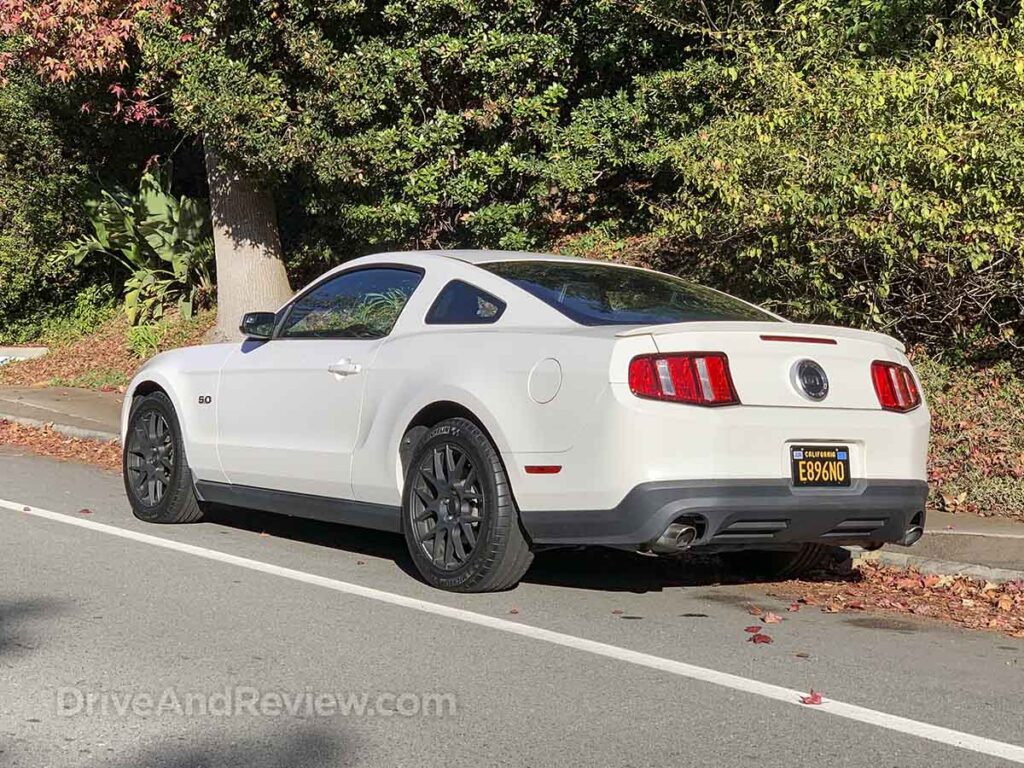 White 2012 Ford Mustang GT with black wheels (rear three-quarter view)