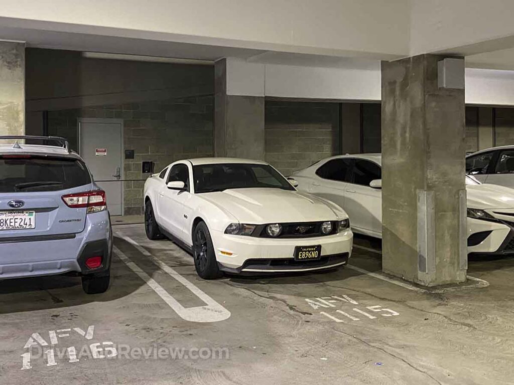 My white 2012 ford mustang gt parked in a parking garage